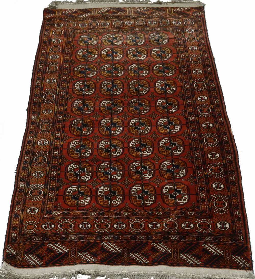 Appraisal: AFGHAN BOKHARA STYLE RUG Four columns of nine octagonal guls