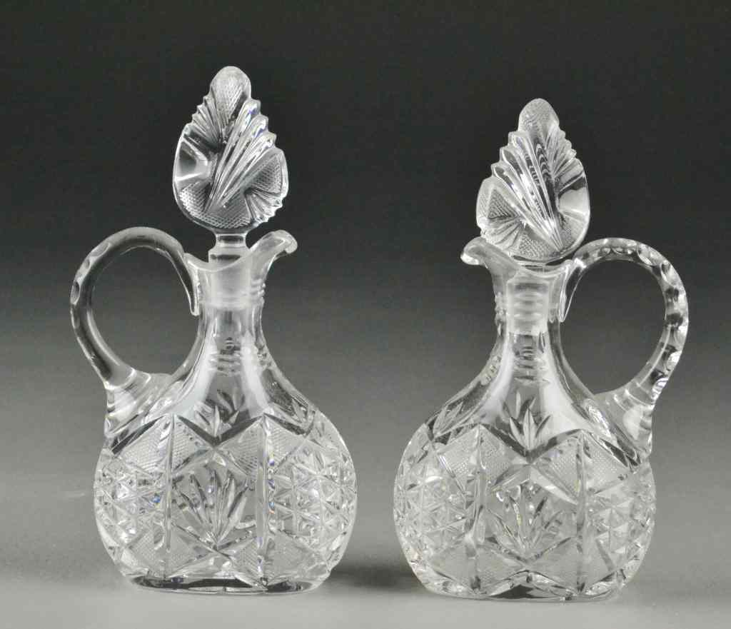 Appraisal: Pair of Cut Crystal Cruets PitcherCruets with handle and stoppers