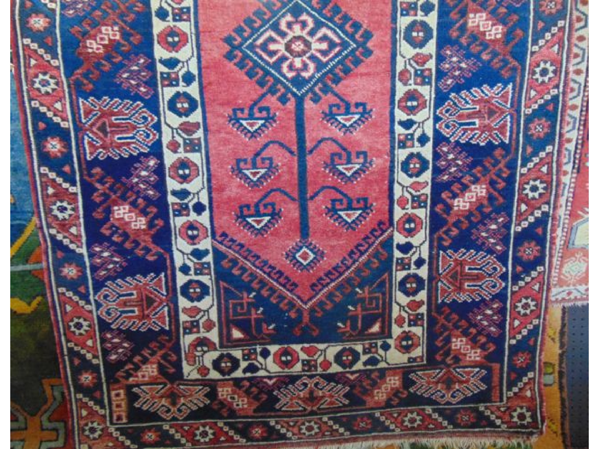 Appraisal: A Persian wool carpet with central medallion upon a pink