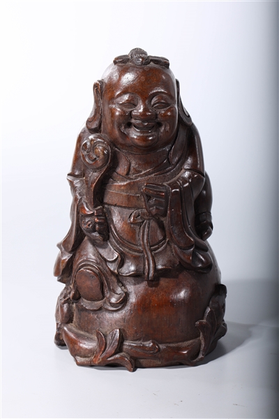 Appraisal: Chinese carved wood seated figure holding a ruyi scepter x