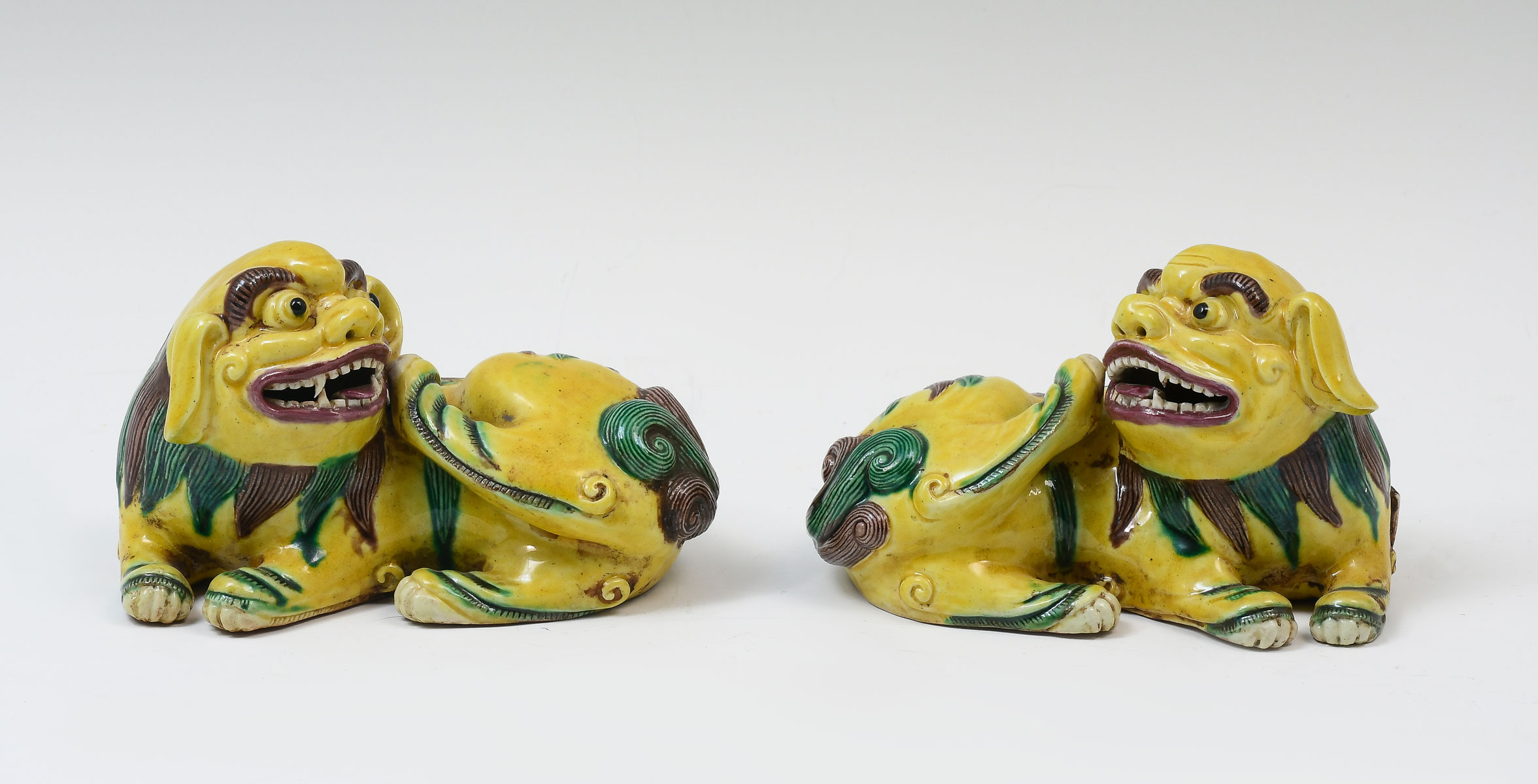 Appraisal: CHINESE PORCELAIN FOO DOGS OPPOSING Chinese porcelain Sancai Foo Lions