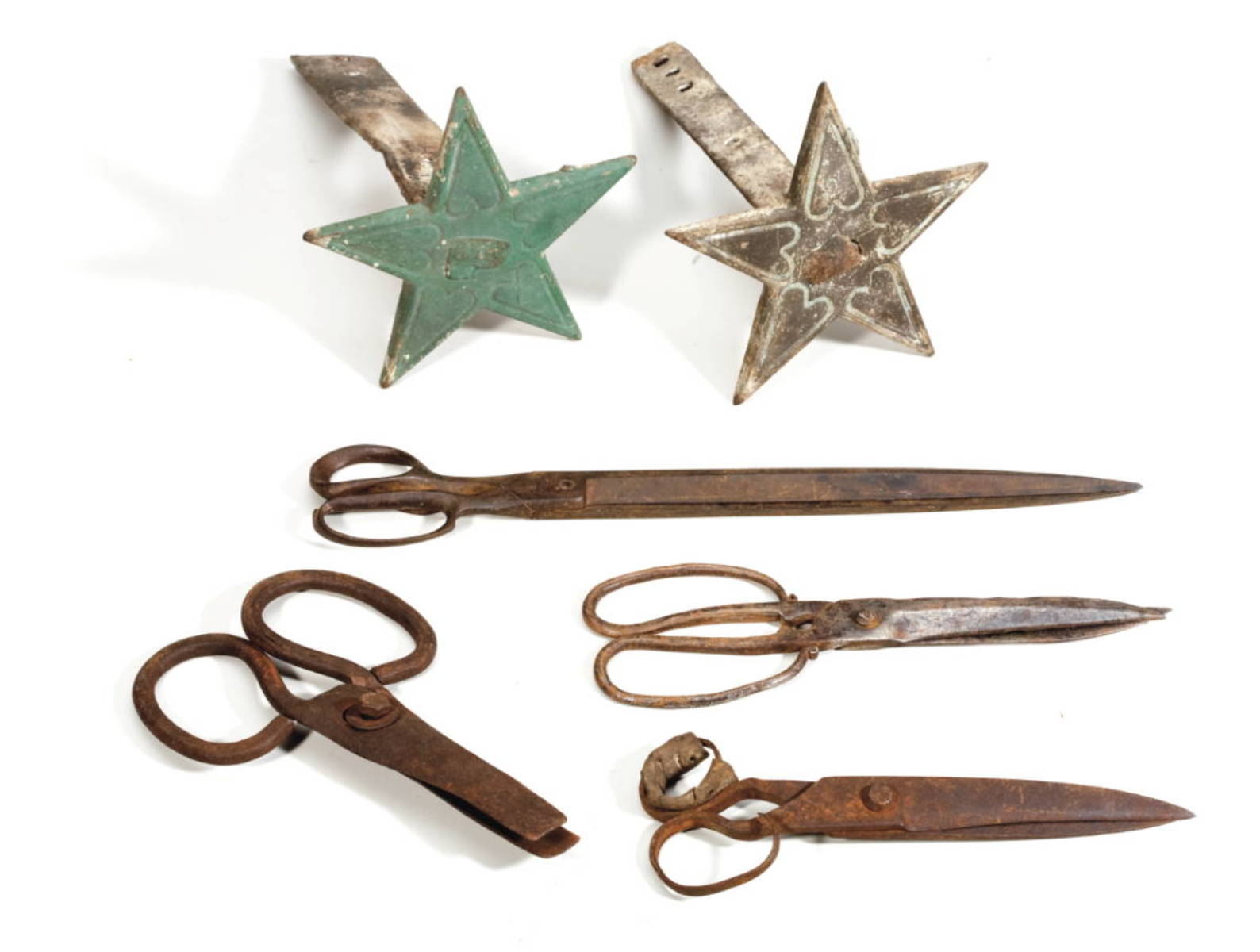 Appraisal: TWO SIMILAR CAST IRON STAR-FORM BUILDING ORNAMENTS WITH HEART MOTIF