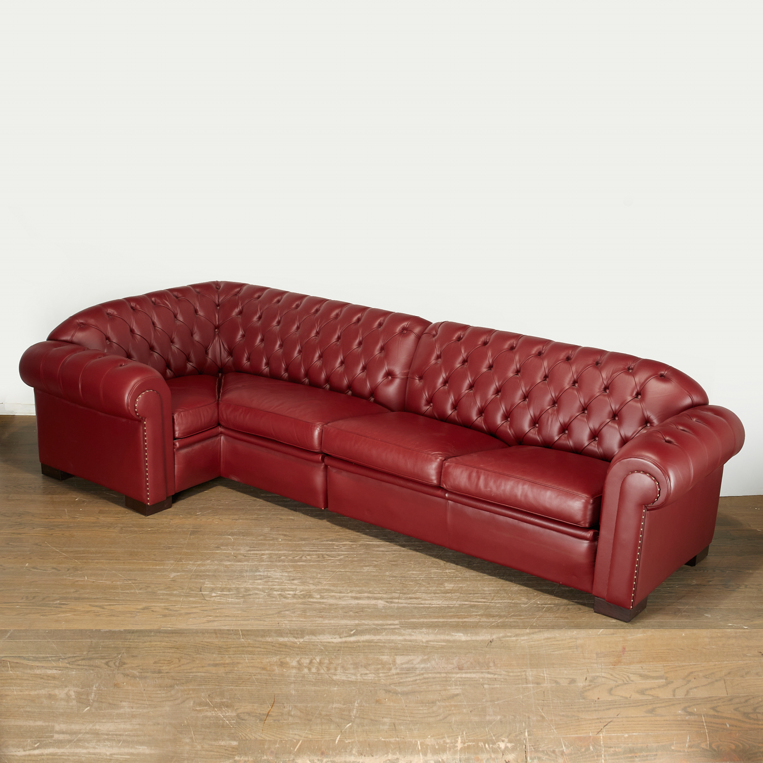 Appraisal: JUAN PABLO MOLYNEUX CUSTOM TUFTED SECTIONAL SOFA th c burgandy