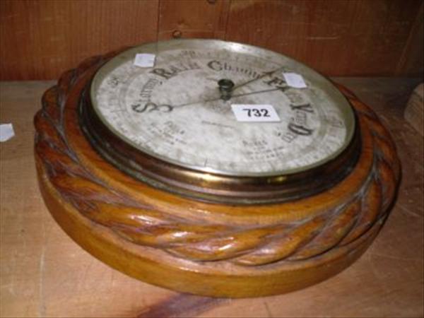 Appraisal: A Victorian circular aneroid barometer with oak ropetwist frame inscribed