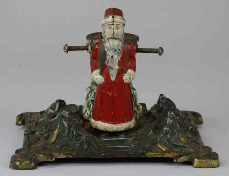 Appraisal: SANTAS CAST IRON CHRISTMAS TREE STAND Germany features Santas figure