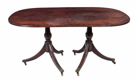 Appraisal: A Regency Style Mahogany Double Pedestal Extension Table having a