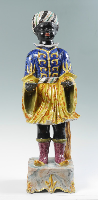 Appraisal: POLYCHROME DECORATED BLACKAMOOR STATUE Ceramic figure of a blackamoor standing