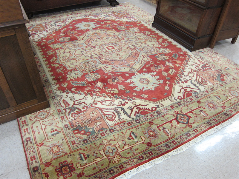 Appraisal: HAND KNOTTED ORIENTAL CARPET Persian Serapi design stylized floral and