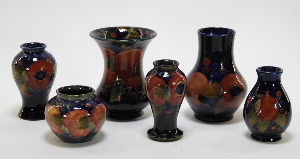 Appraisal: MOORCROFT POTTERY POMEGRANATE PATTERN VASES England th centurySix Moorcroft Pomegranate