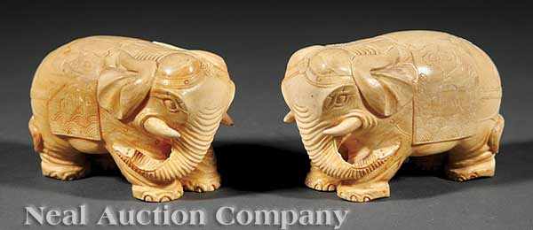 Appraisal: A Pair of Chinese Ivory Elephants each solidly carved caparisoned