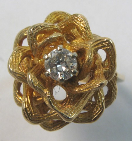 Appraisal: DIAMOND AND FOURTEEN KARAT GOLD RING centering a round brilliant-cut