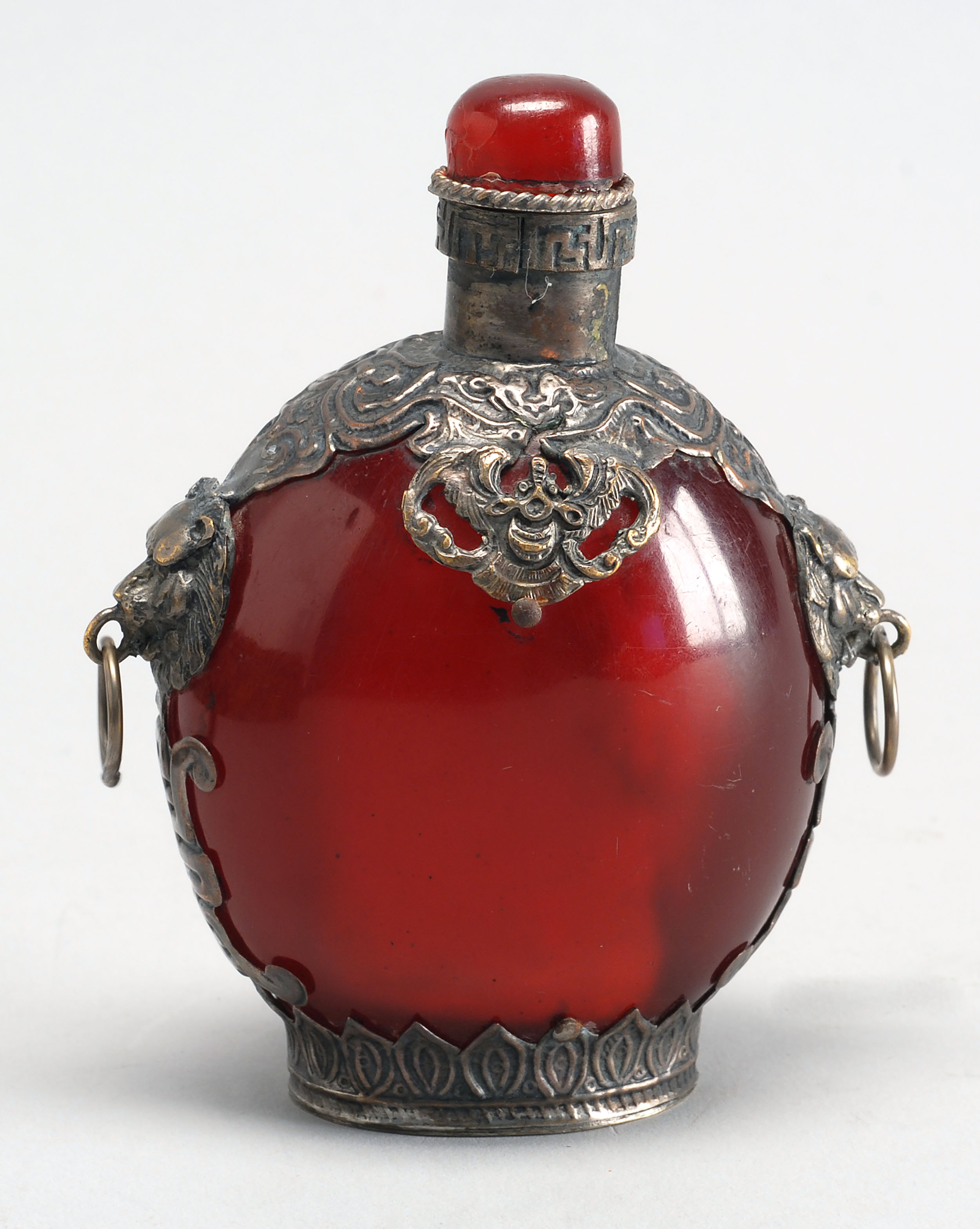 Appraisal: RUBY GLASS SNUFF BOTTLE In ovoid form with silver plated