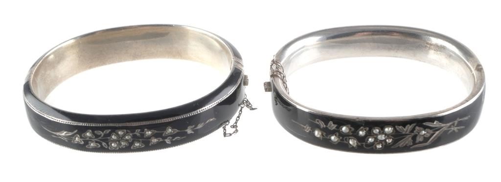 Appraisal: Pair of black enamel bracelets on sterling silver engraved floral