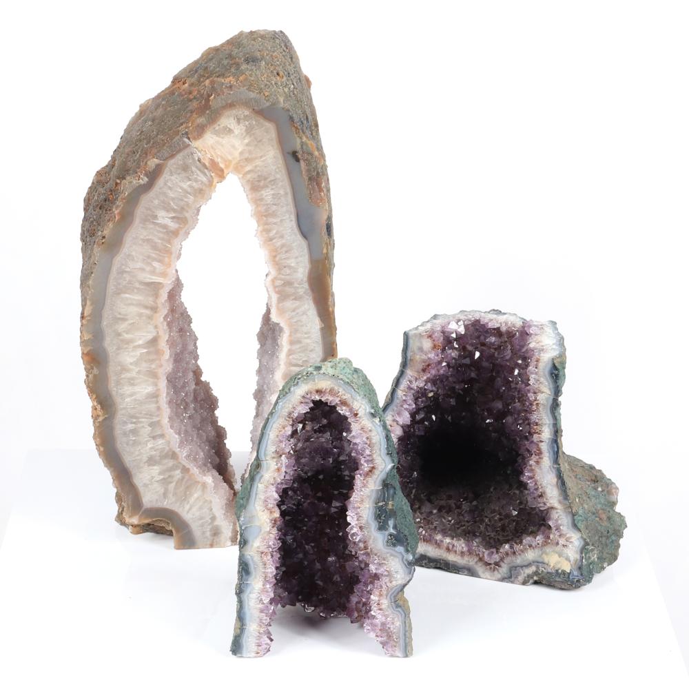 Appraisal: THREE NATURAL ROCK CRYSTAL CATHEDRAL AMETHYST SPECIMENS H X W