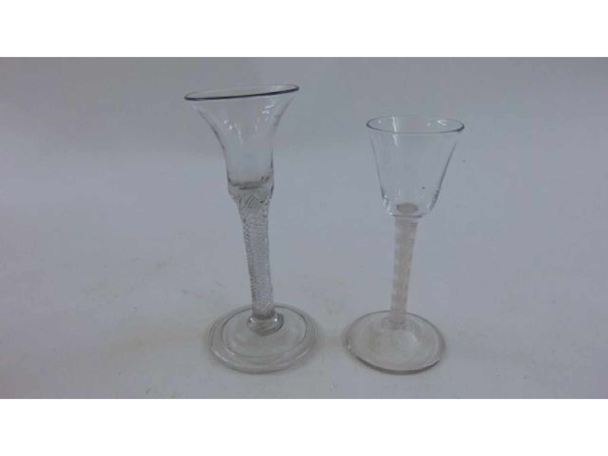 Appraisal: A hand blown drinking glass with clear bell shaped bowl