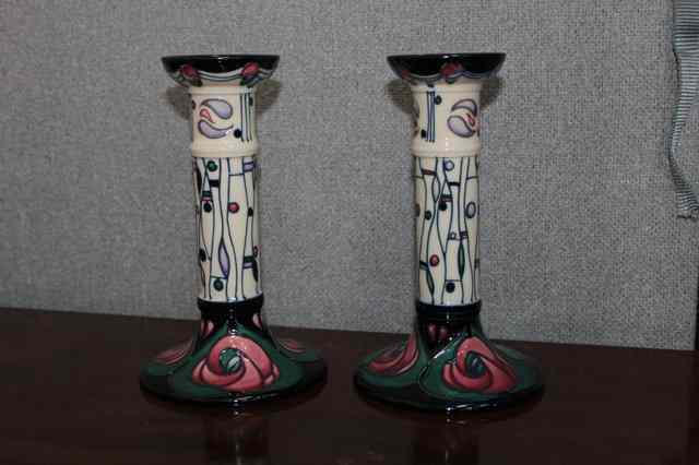 Appraisal: A PAIR OF MOORCROFT POTTERY CANDLESTICKS of stylised floral design