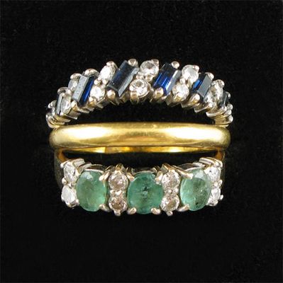 Appraisal: An emerald and diamond eleven stone gold ring A sapphire