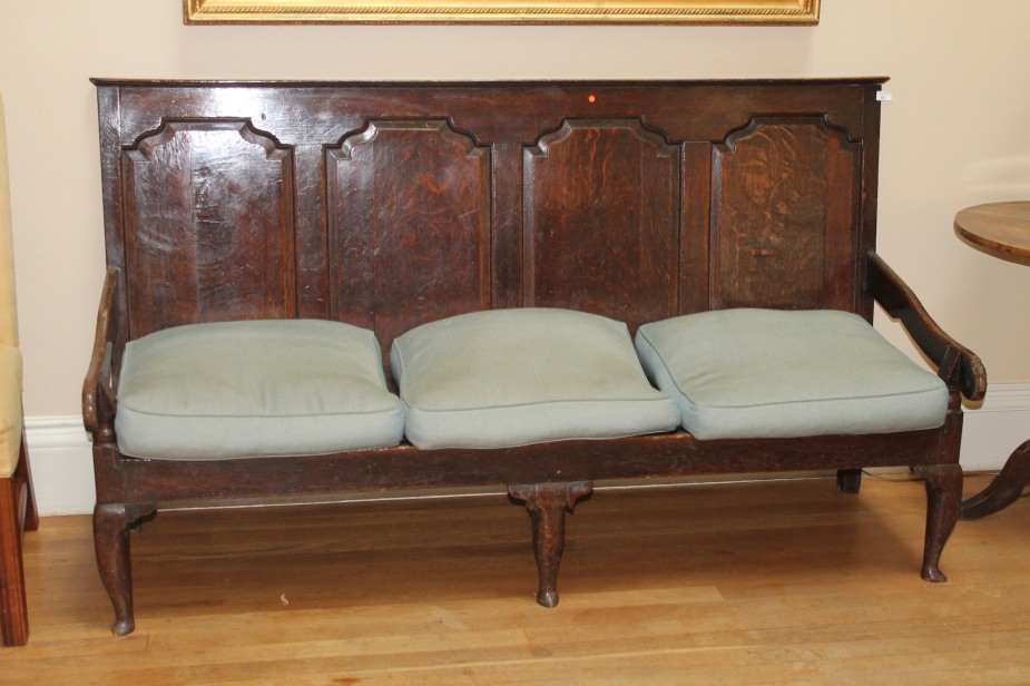 Appraisal: An early thC oak settle with four fielded panels to