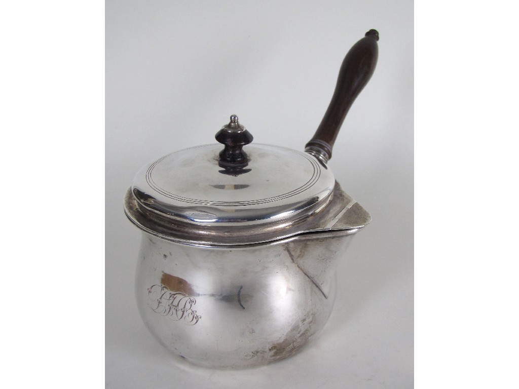 Appraisal: A George III silver brandy pan the slightly domed cover