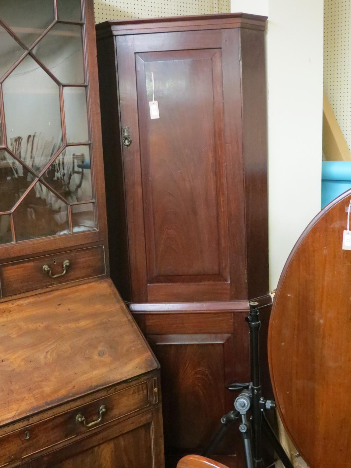 Appraisal: A solid mahogany standing corner cupboard enclosed by two fielded