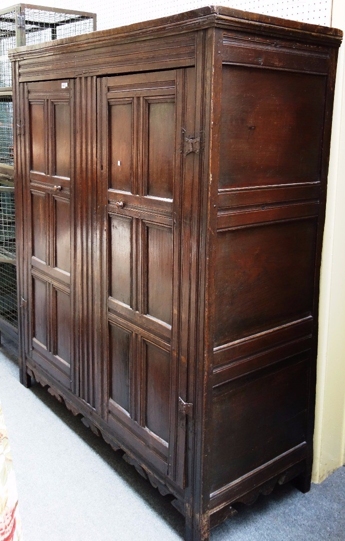 Appraisal: A th century and later oak cupboard with pair of