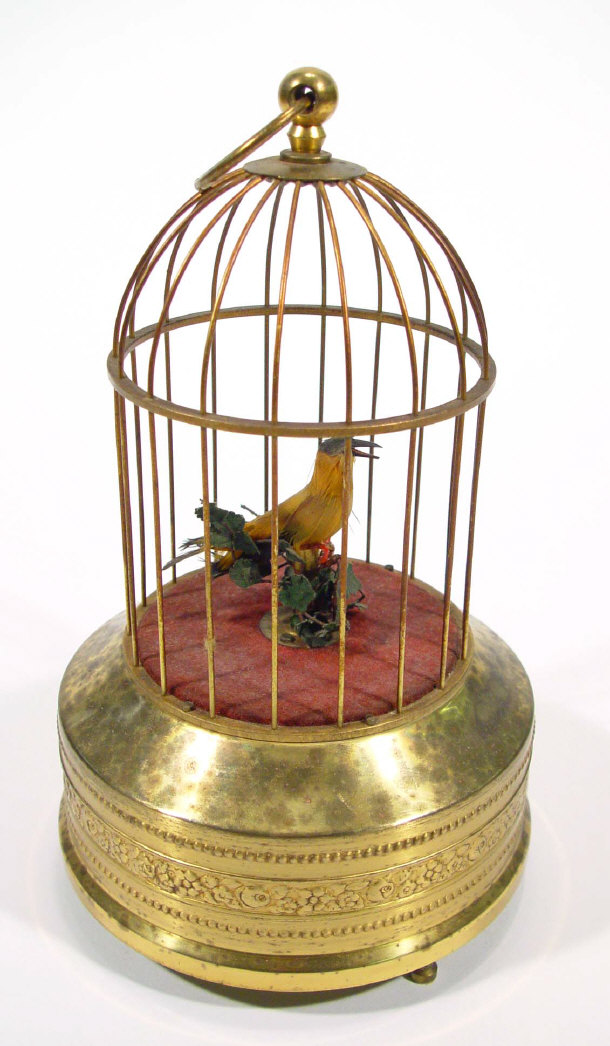 Appraisal: Clockwork bird in a wire cage automata musical box cm