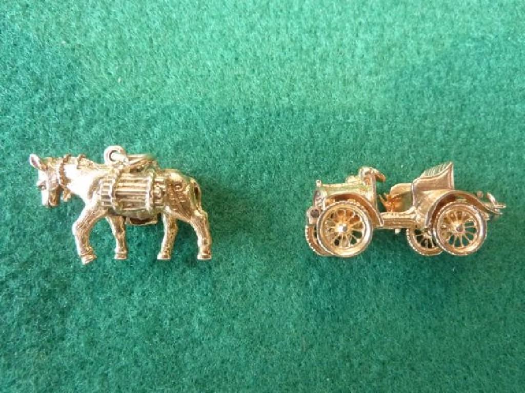 Appraisal: Two ct yellow gold charms modelled as a veteran car