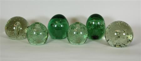 Appraisal: SIX GREEN GLASS DUMP PAPERWEIGHTS two with internal flowers two