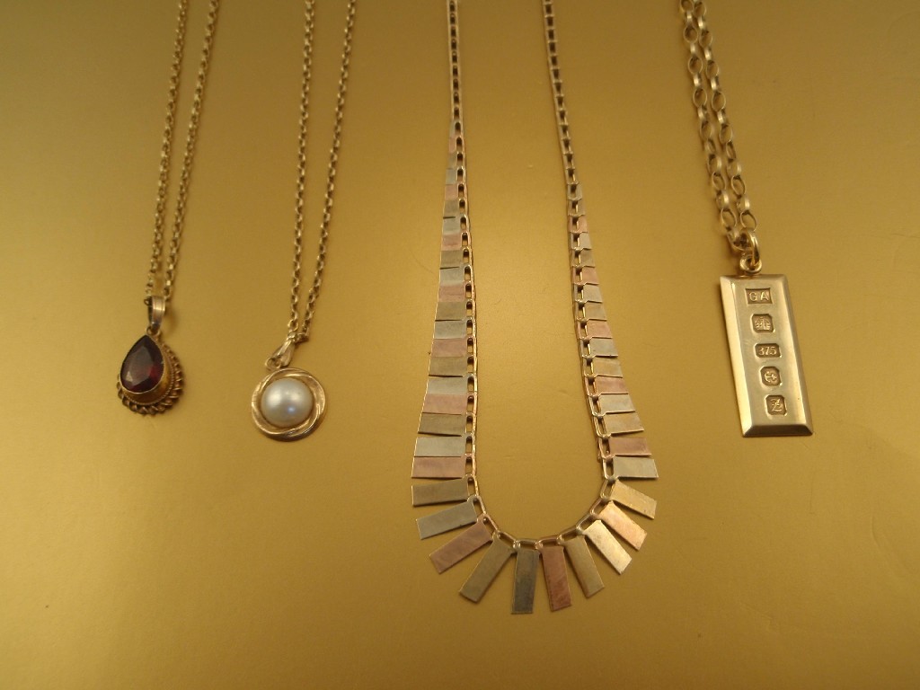 Appraisal: Three ct gold pendant necklaces and a tricolour brickette necklace