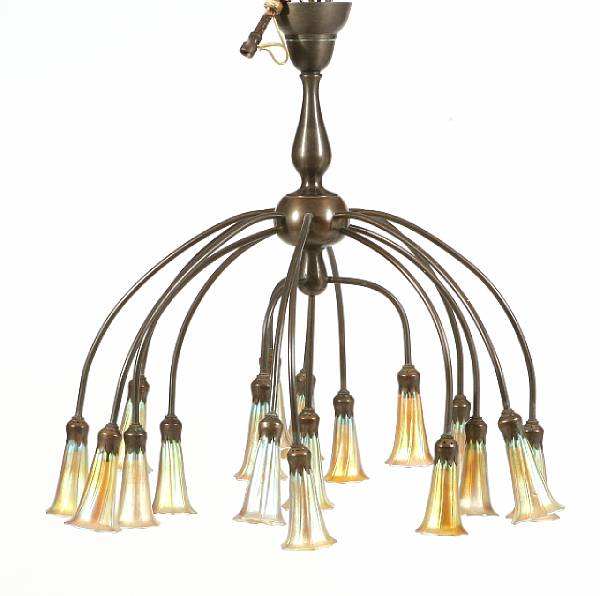 Appraisal: A Tiffany style bronze and iridescent glass eighteen-light chandelier height