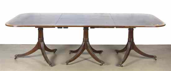 Appraisal: A Georgian Style Mahogany Triple Pedestal Dining Table the banded