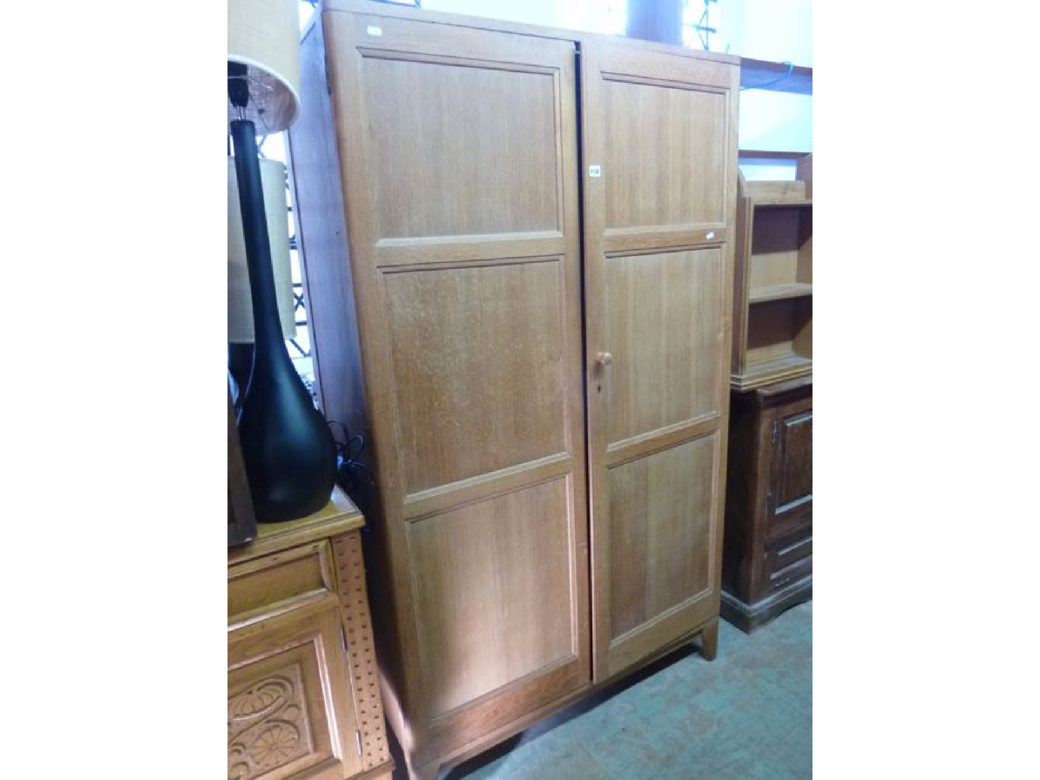 Appraisal: A stripped oak hanging cupboard enclosed by two panelled doors