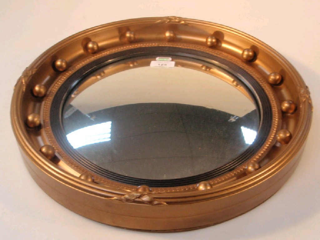 Appraisal: A Regency style convex wall mirror with gilt frame having