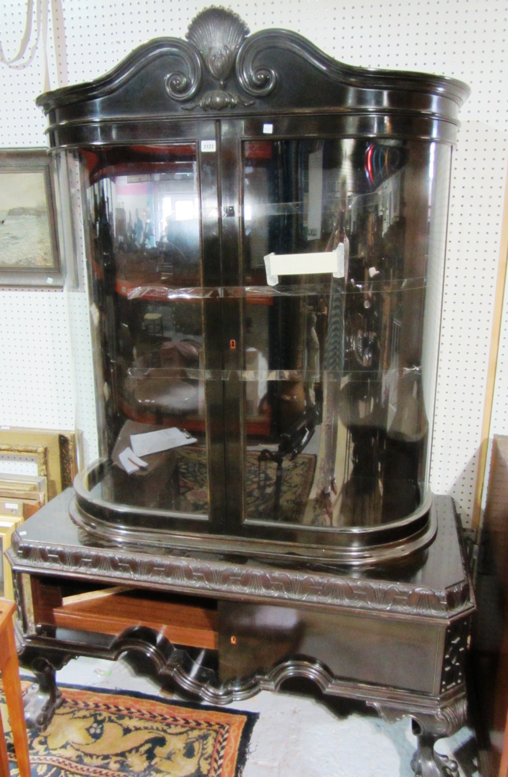 Appraisal: A th century ebonised double bowfronted door display cabinet on