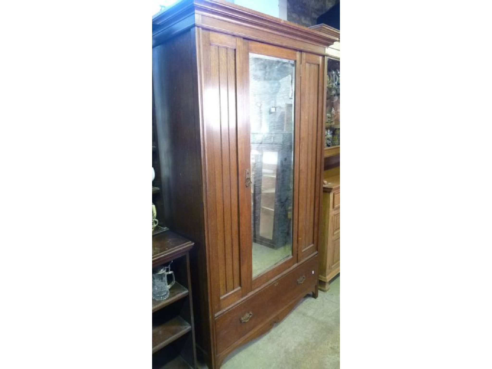 Appraisal: An Edwardian oak wardrobe the central mirror panelled door over