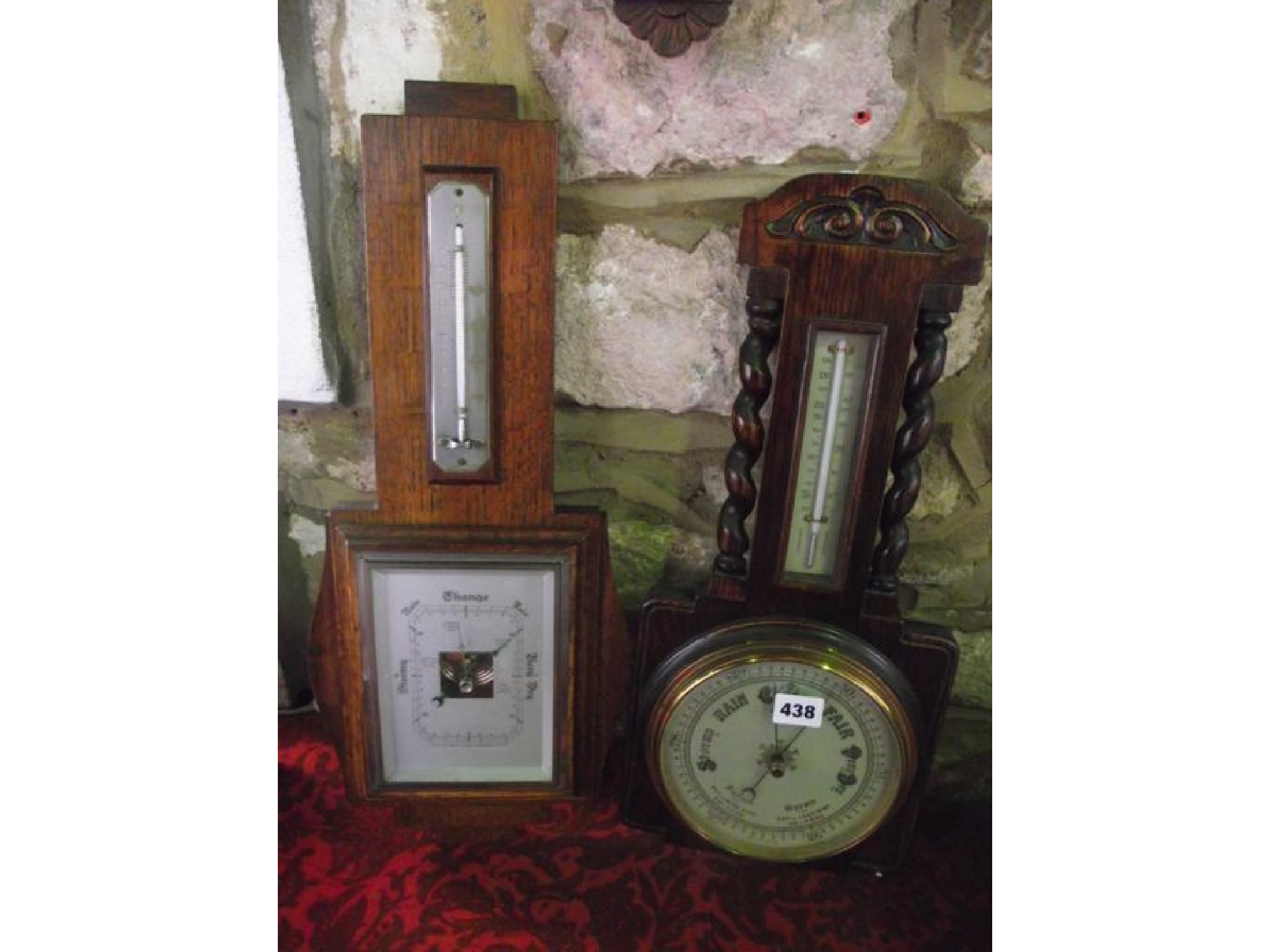 Appraisal: An Edwardian aneroid barometer in an oak case with barley