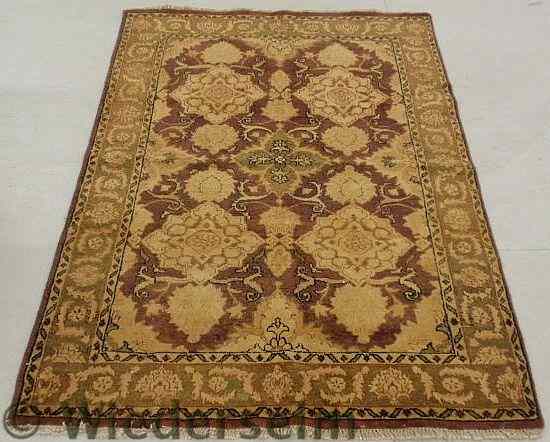 Appraisal: Oriental center hall carpet in muted browns and burgundy and