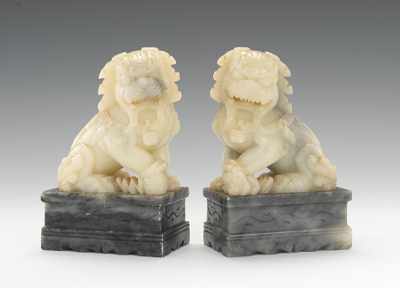 Appraisal: A Pair of Carved Jade Foo Dogs Both carved of