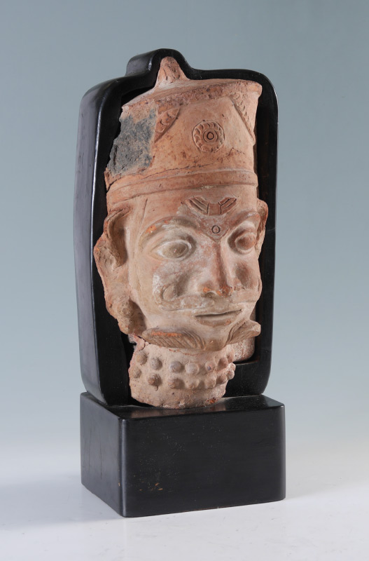 Appraisal: SINO-TIBETAN FIGURAL ARCHITECTURAL FRAGMENT Terracotta figure of a head originally