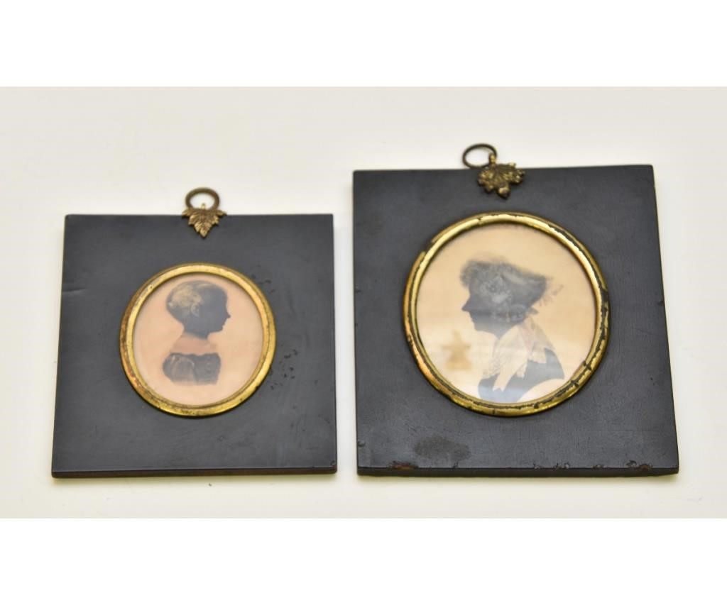 Appraisal: Two miniature oval watercolor silhouettes early th c mounted in