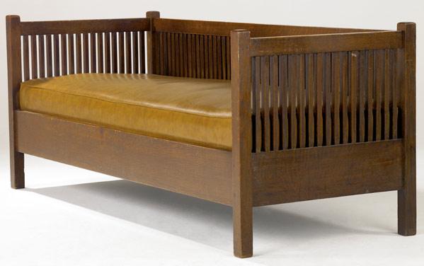 Appraisal: GUSTAV STICKLEY Spindled cube settle with a drop-in spring seat