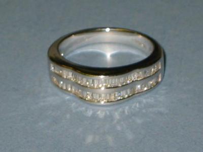 Appraisal: A DIAMOND HALF HOOP DRESS RING comprising two rows of