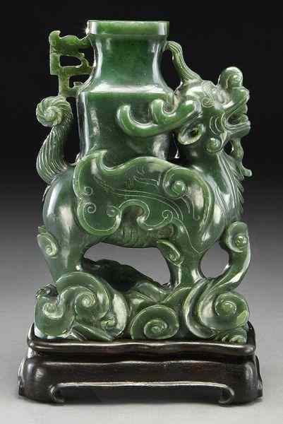 Appraisal: Chinese carved celadon jade carvingdepicting a Qilin carrying a vase