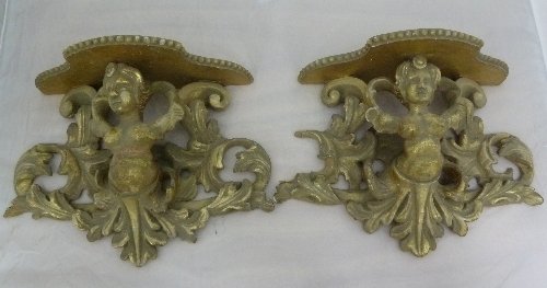 Appraisal: A pair of carved wall sconces the shaped platform on