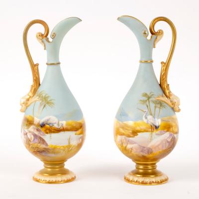 Appraisal: A pair of Royal Worcester small ewers each painted with