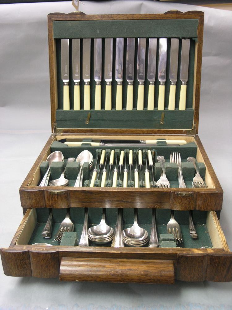 Appraisal: A 's suite of silver plated cutlery contained within oak