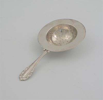 Appraisal: By Georg Jensen A modern Danish tea strainer sinuous stem