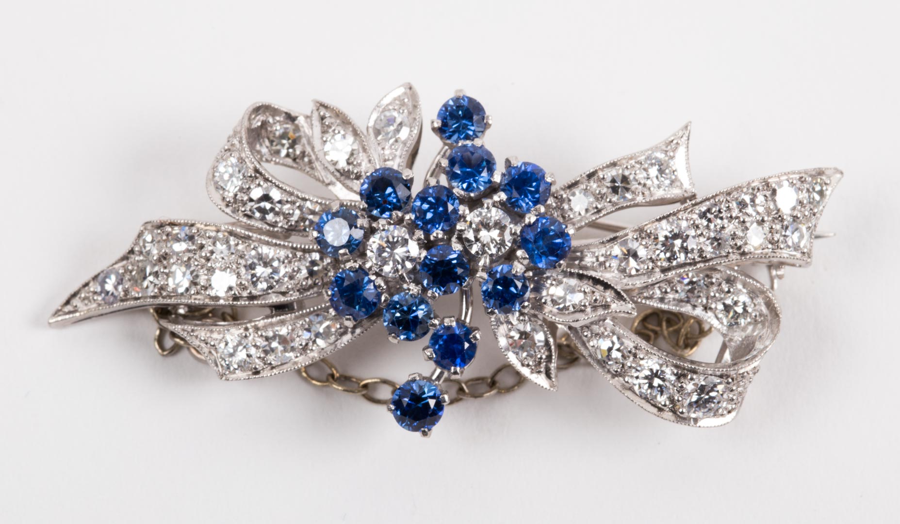 Appraisal: A Platinum Diamond Sapphire Bow Pin wide