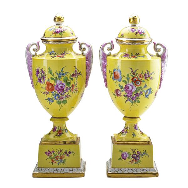 Appraisal: PAIR OF GERMAN PORCELAIN URNS Hand-painted floral decoration on yellow