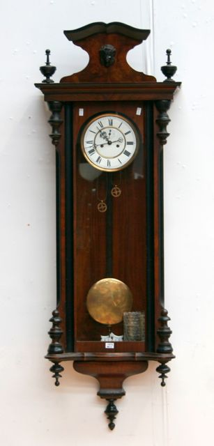 Appraisal: A walnut cased Vienna regulator clock with armorial and finials